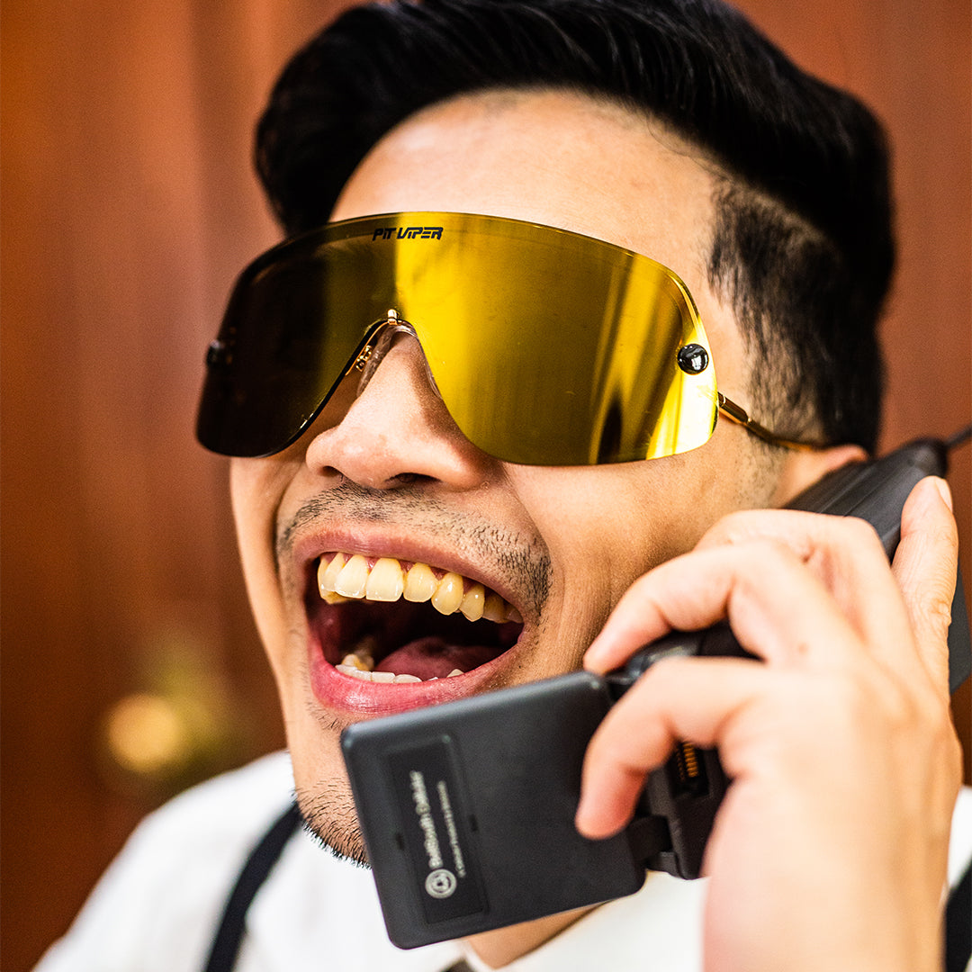 / Polarized Gold | Man on the phone wearing The Money Counter Limousine from Pit Viper Sunglasses