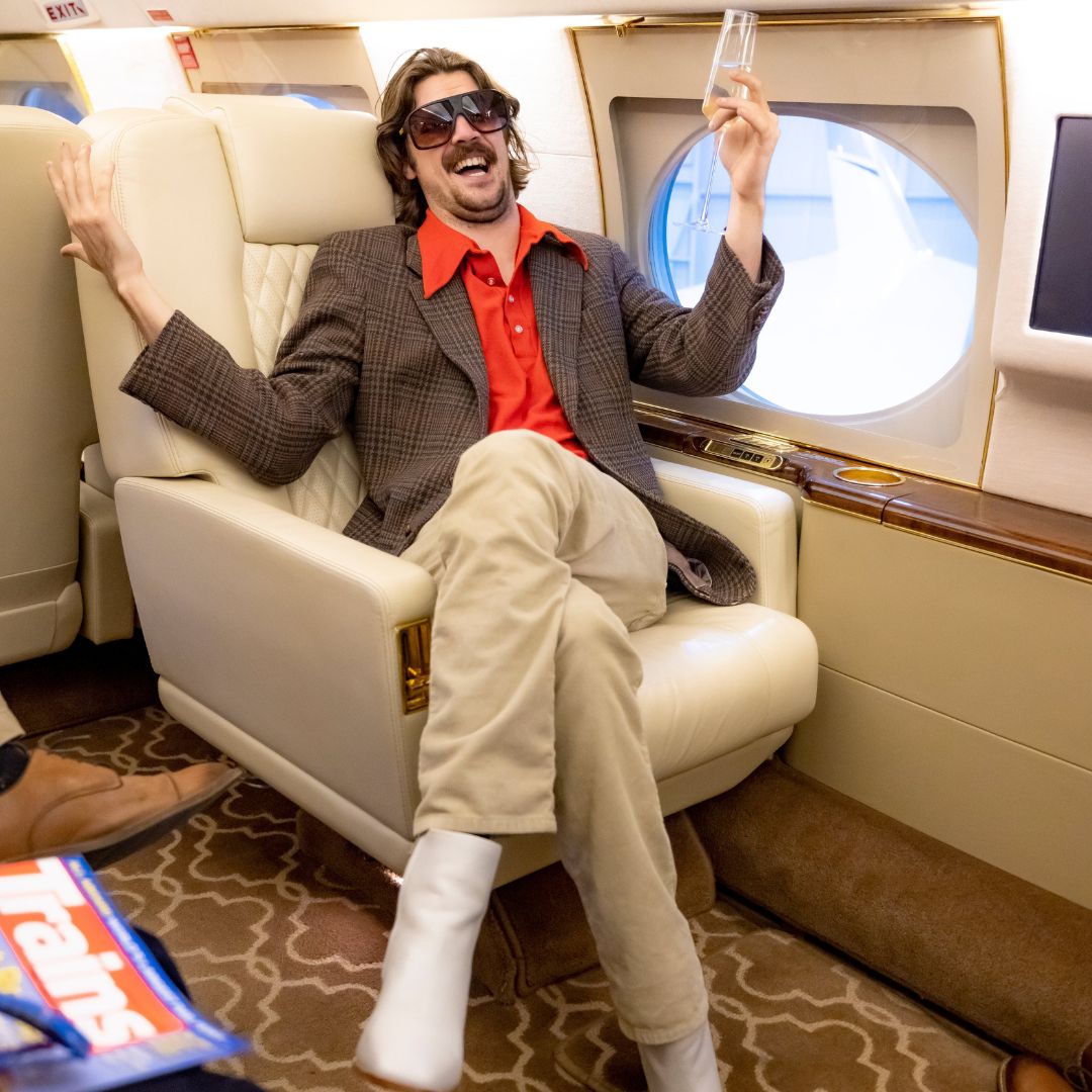 / Brown Fade | A man smiling drinking champagne wearing Pit Viper Sunglasses