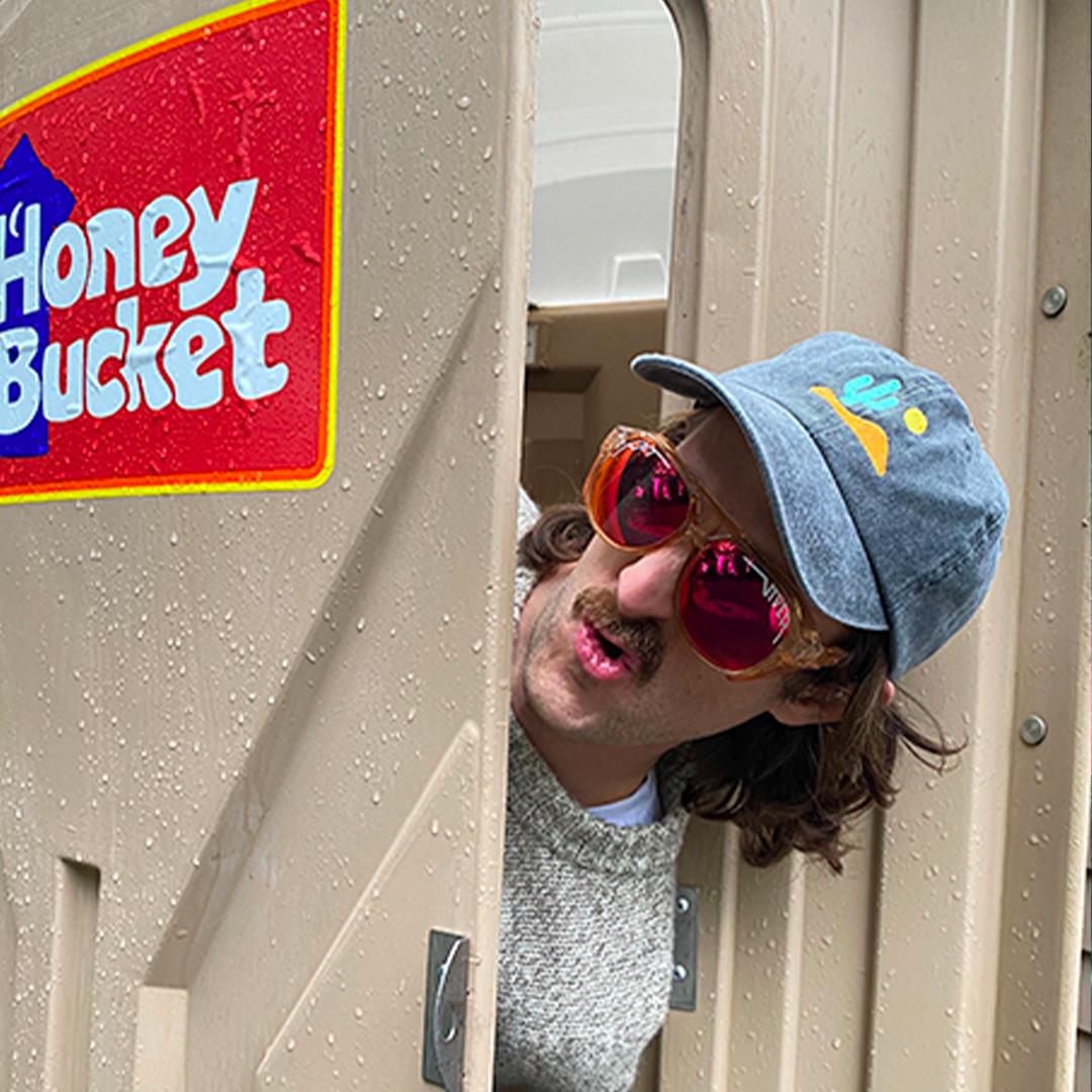 / Polarized Z87+ Red | Man peaking out of a port-a-potty wearing the Courduroy Exciters from Pit Viper Sungasses