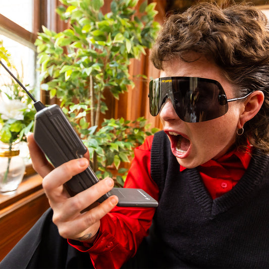 / Polarized Smoke | Woman screaming at a phone wearing The Exec Limousine from Pit Viper Sunglasses